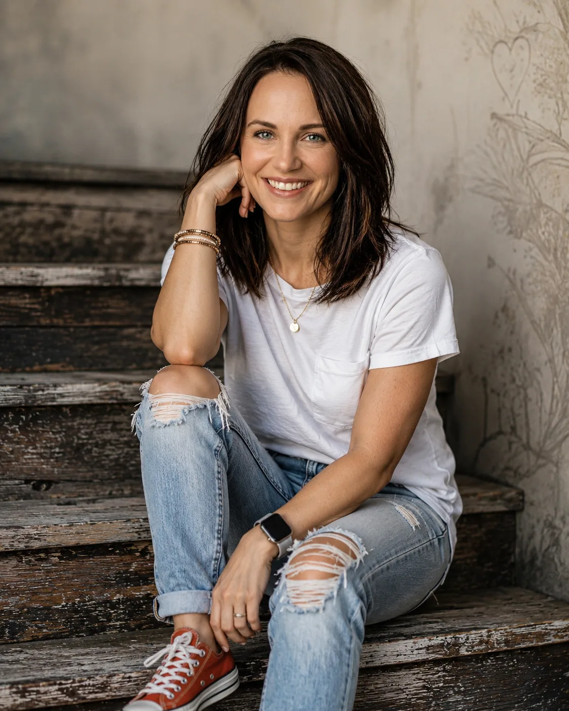 A woman sitting on rustic steps.
